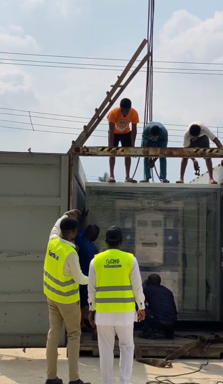 Technicians guiding a packaged CNG module during offloading
