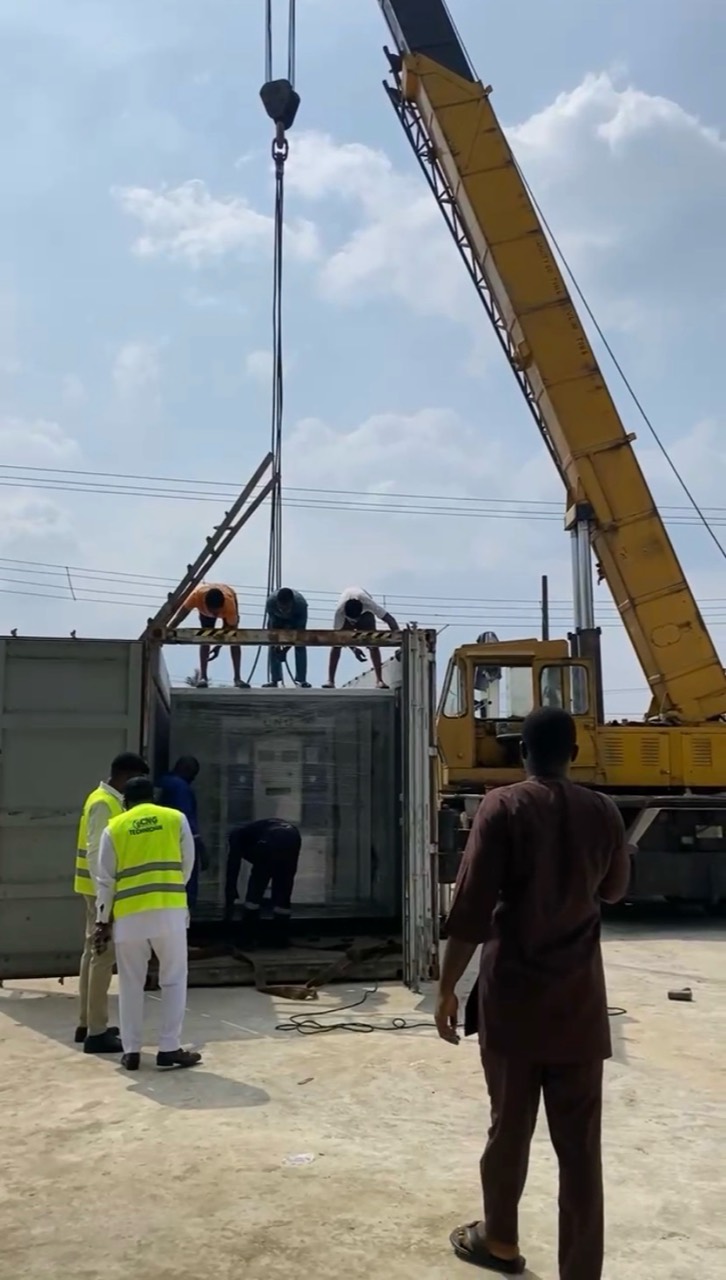 Packaged CNG module being lifted from a shipping container